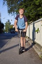 Boy with scooter on the street Royalty Free Stock Photo