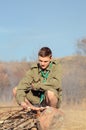 Boy Scout Cooking Sausages on Stick over Campfire Royalty Free Stock Photo