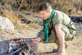 Boy Scout Cooking Sausages on Stick over Campfire