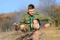 Boy Scout Cooking Sausages on Stick over Campfire Royalty Free Stock Photo