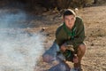 Boy Scout Making Fire on the Campground