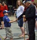 Boy Scout Shakes Hand of Veteran at Parade