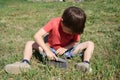 Boy scout sharpening axe Royalty Free Stock Photo