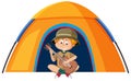 A boy scout in uniform playing guitar the camping tent Royalty Free Stock Photo