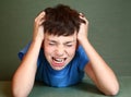 Boy scratch his head isolated on blue Royalty Free Stock Photo