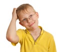 Boy scratches his head in puzzlement or confusion Royalty Free Stock Photo