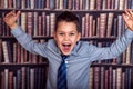 Boy screaming in library Royalty Free Stock Photo