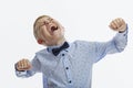 The boy screams emotionally. Child 9-10 years old in a blue shirt. Difficulty communicating and learning. White background Royalty Free Stock Photo