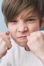 Boy screams and jokingly threatens with his fists in fighting stance Royalty Free Stock Photo