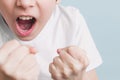 Boy screams and jokingly threatens with his fists in fighting stance Royalty Free Stock Photo