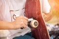 Boy screws the truck on the skateboard After sticker griptape Royalty Free Stock Photo