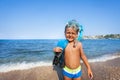 Boy with scuba mask and paddles on the seashore Royalty Free Stock Photo