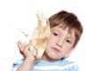 Boy with sea shell over white Royalty Free Stock Photo