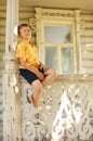Boy seat on handrails on terrace