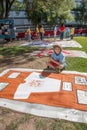 Boy with Section of AIDS Quilt