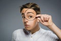 Boy See Through Magnifying Glass, Kid Eye Looking with Magnifier Lens over Gray Royalty Free Stock Photo