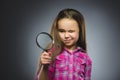 Boy See Through Magnifying Glass, Kid Eye Looking with Magnifier Lens over Gray Royalty Free Stock Photo