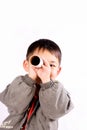 Boy seeing through paper tube