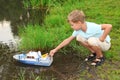 Boy sends toy ship in floating Royalty Free Stock Photo