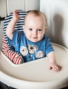 Boy seven months old sitting in chair