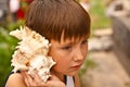 Boy with a shell Royalty Free Stock Photo