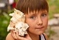Boy with a shell Royalty Free Stock Photo