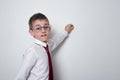 Boy in shirt, tie and glasses writes on the board. High school student. Copy space