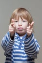 Boy shooting with his fingers Royalty Free Stock Photo