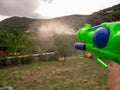 Boy shooting water dispersion with water gun Royalty Free Stock Photo