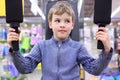 Boy in shop on sports exerciser Royalty Free Stock Photo