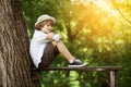 Boy in shorts and a hat sits Royalty Free Stock Photo