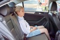 Cute sad boy sitting in a car wearing a seat belt Royalty Free Stock Photo