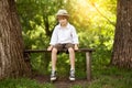 Boy in shorts sits on a bench Royalty Free Stock Photo