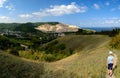 A boy in shorts and a T-shirt goes down the path against the backdrop of a verdant valley and the Volga River. Royalty Free Stock Photo