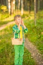 Boy shouting out loud in the forest with hands cupped around mouth Royalty Free Stock Photo