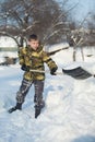 Boy shoveling snow from walkway Royalty Free Stock Photo