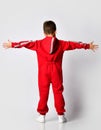 Boy showing back side of red warm jumpsuit