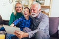 Boy showing his older grandparents new technology Royalty Free Stock Photo