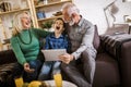 Boy showing his older grandparents new technology Royalty Free Stock Photo