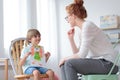 Boy showing picture to counselor Royalty Free Stock Photo