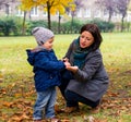 Boy showing woman chestnut