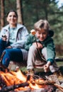 Boy shows beautiful roasred marshmallow on campfire Royalty Free Stock Photo