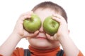Boy shutting eyes with apples Royalty Free Stock Photo