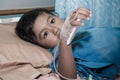 boy sick lying on patient bed,hand in saline