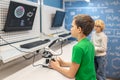 Boy sideways to camera looking intently at charging board