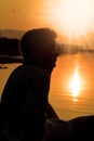 Boy silhouette, sunset at lake Royalty Free Stock Photo