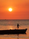 Boy silhouetted on boat at sunset, Stone Town on island of Zanzibar Royalty Free Stock Photo