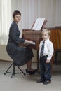 Boy Singing As Teacher Play The Piano Royalty Free Stock Photo