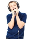 Boy singing into a microphone. Very emotional. Royalty Free Stock Photo