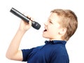 Boy singing into a microphone. Very emotional. Royalty Free Stock Photo